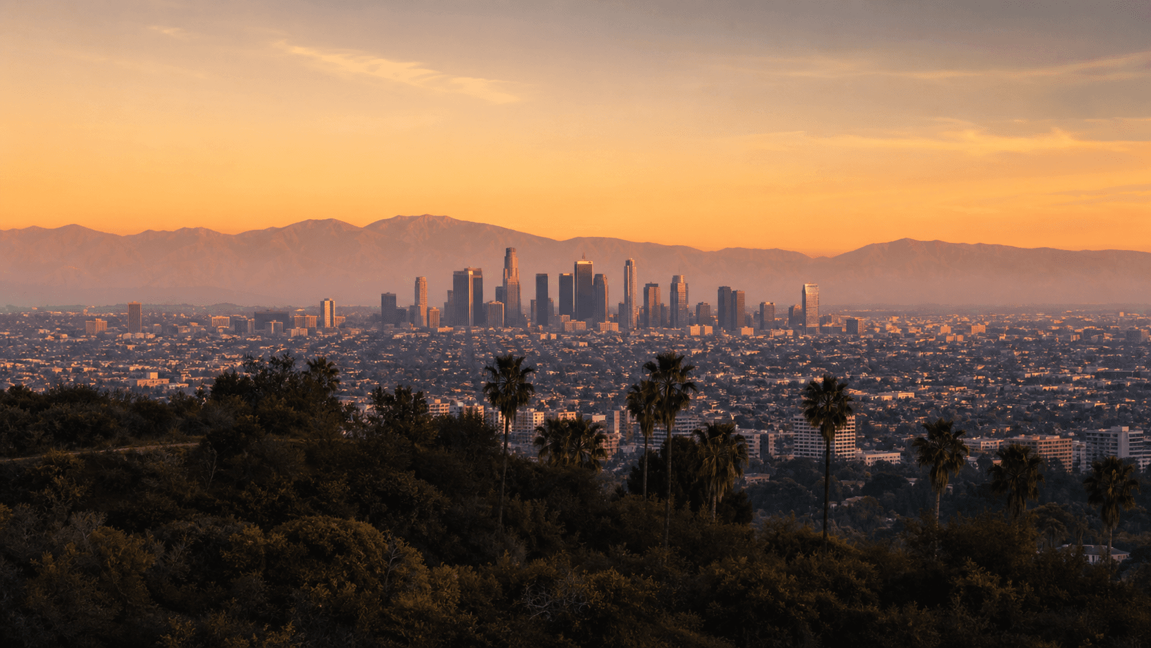 Los Angeles skyline and mountains at golden hour from Griffith Park